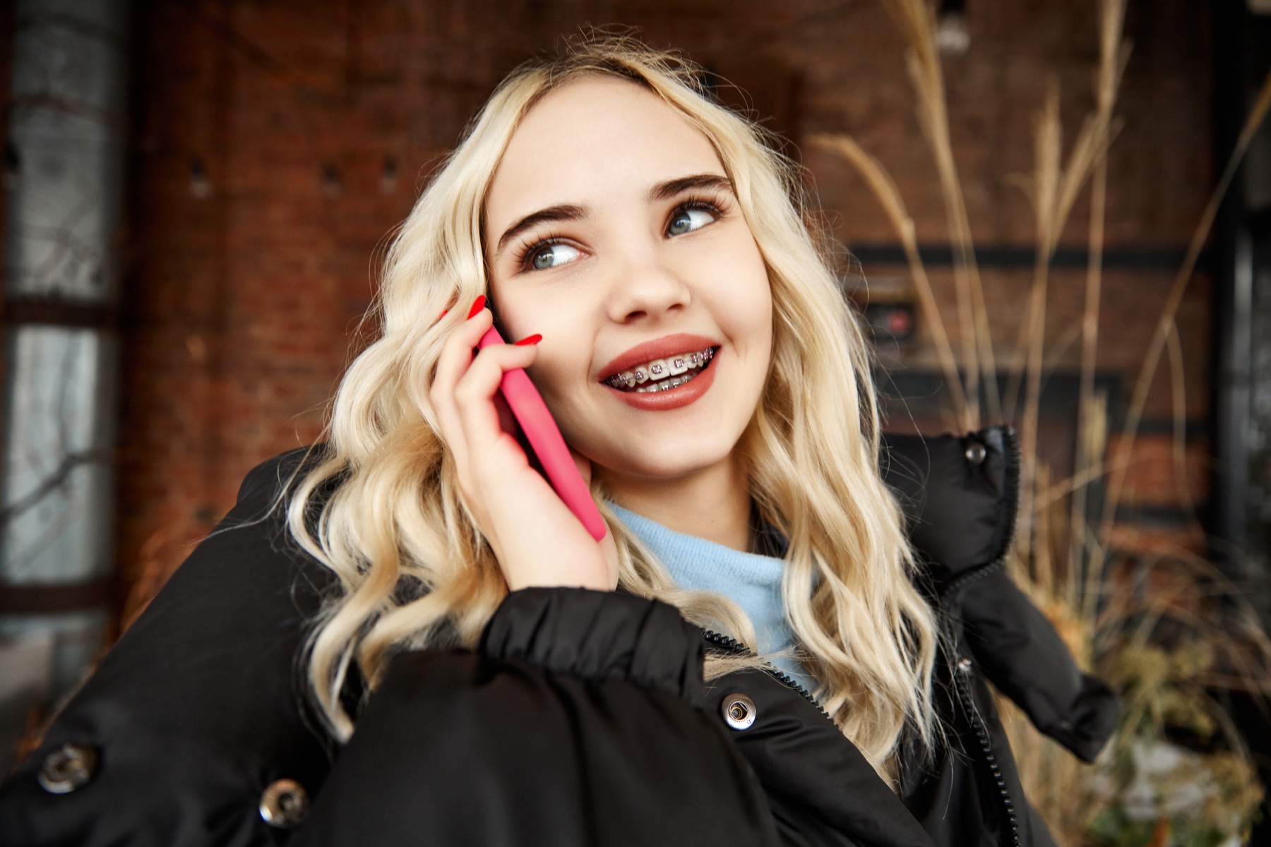 Woman on her phone reviewing a monthly payment plan