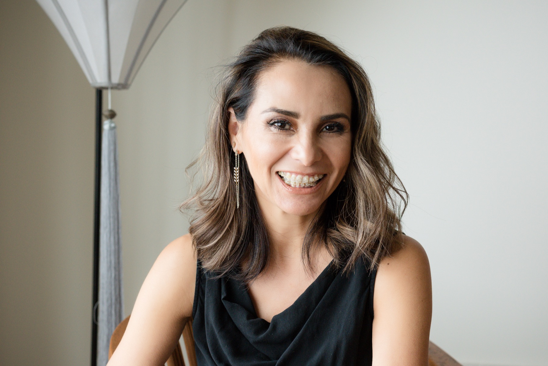 A woman smiling during discreet brace treatment