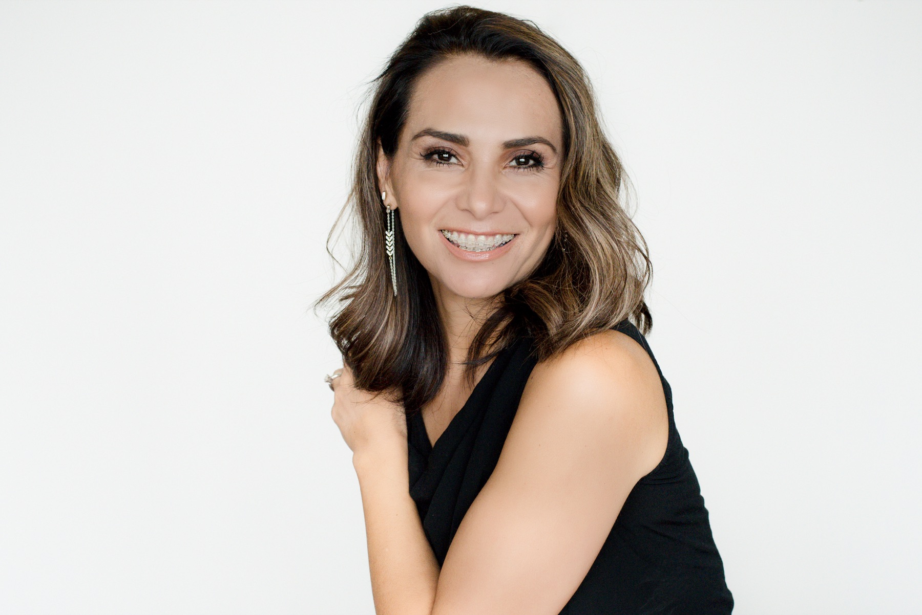 Woman smiling with brackets hidden on the inner tooth surfaces