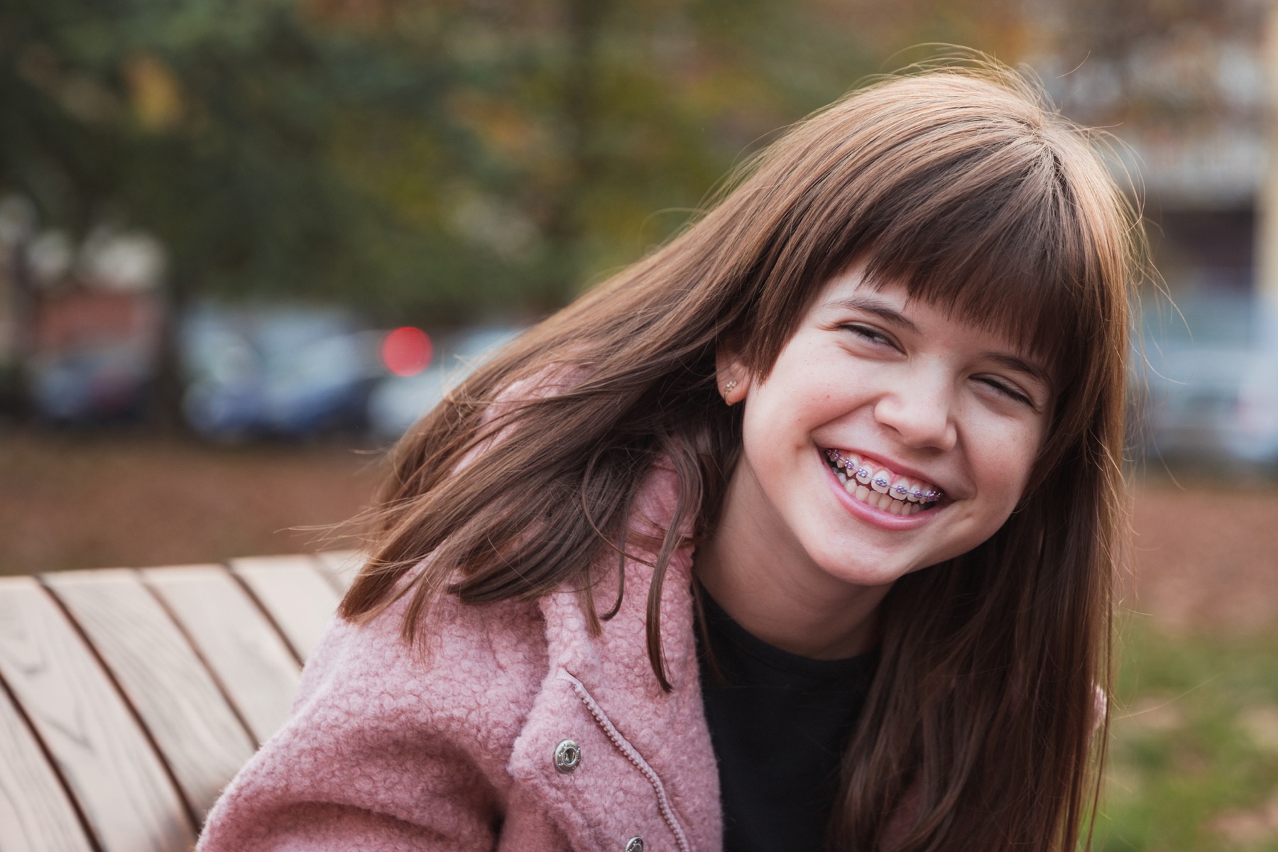 A laughing girl wearing metal braces
