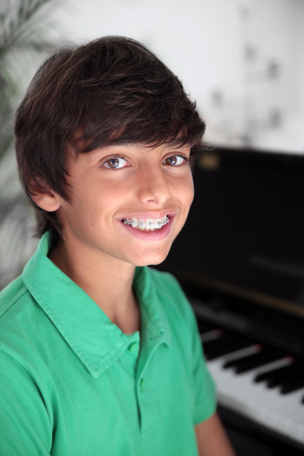 A young boy grinning with his braces fitted