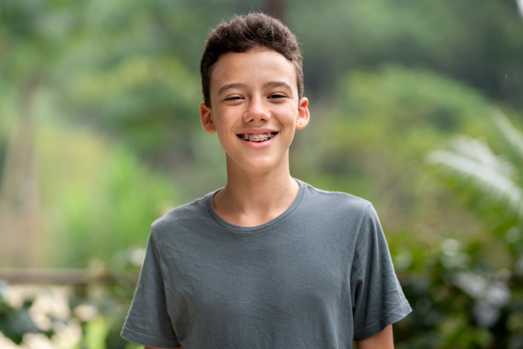 A smiling teenage boy who has finished NHS brace treatment